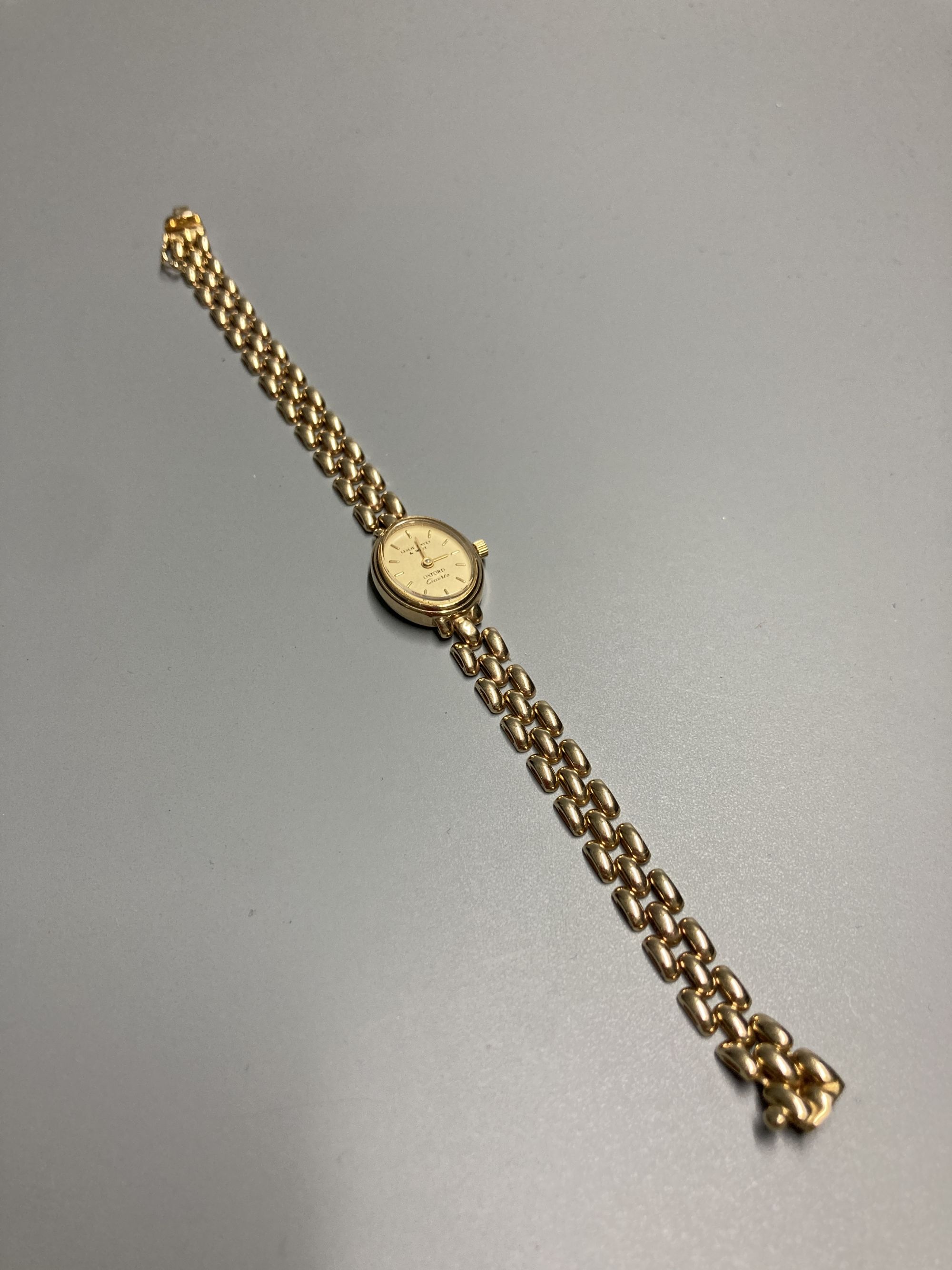 A ladys modern 9ct. gold quartz wrist watch with 9ct gold strap, gross 14.7 grams.